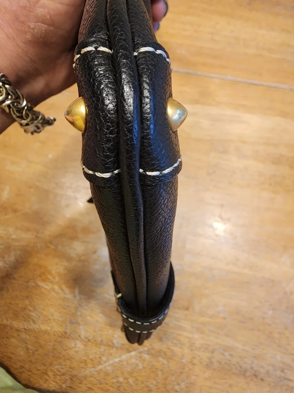 vintage Dooney & Bourke black leather shoulder bag featuring gold-tone hardware